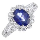 A sapphire and diamond cluster ring.Sapphire weight 1.59cts.Total diamond weight 0.79ct,