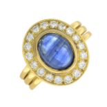 A sapphire cabochon and diamond cluster ring.Sapphire calculated weight 2.20cts,