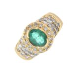 An emerald and diamond cluster ring.Emerald calculated weight 0.60cts,