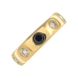 An 18ct gold diamond and black gem band ring.Estimated total diamond weight 1.30cts,