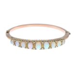 An opal and diamond bangle.Inner diameter 5.7cms.