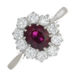 A ruby and diamond cluster ring.Ruby calculated weight 0.85ct,