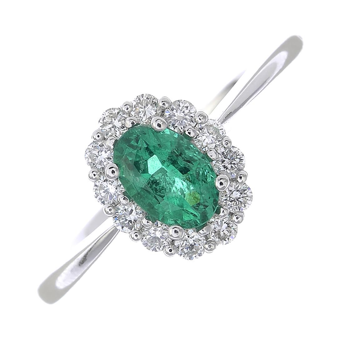 An emerald and diamond cluster ring.Emerald weight 0.43ct,