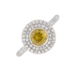 A 'yellow' diamond and diamond cluster ring.Principal diamond estimated weight 0.70ct,