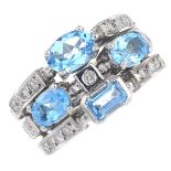 A vari-cut blue topaz and diamond dress ring.