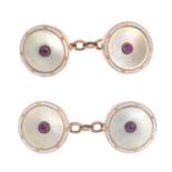 A pair of early 20th century gold, mother-of-pearl, white enamel and ruby cufflinks.