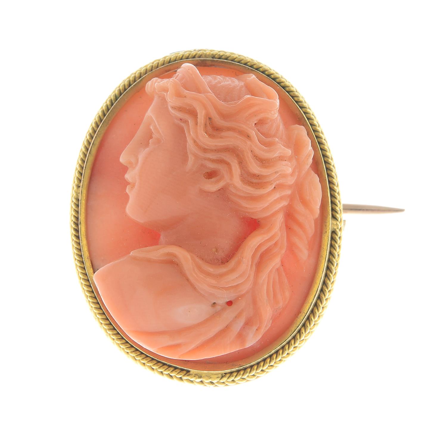 A coral cameo brooch.Estimated dimensions of coral 22 by 17.3 by 8.4mms.Length 2.5cms.