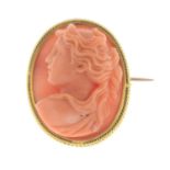 A coral cameo brooch.Estimated dimensions of coral 22 by 17.3 by 8.4mms.Length 2.5cms.