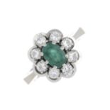 An emerald and diamond cluster ring.Emerald calculated weight 0.40cts,