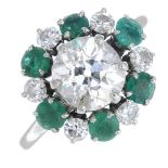 A mid 20th century platinum diamond and emerald cluster ring, by Mauboussin.