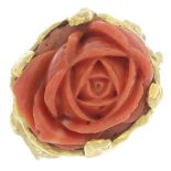 A coral dress ring, the coral carved to depict a flower.Ring size N1/2.