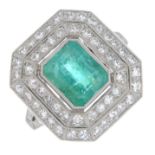 An emerald and diamond cluster ring.