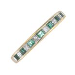 An emerald and diamond half eternity ring.Total diamond weight 0.27ct,