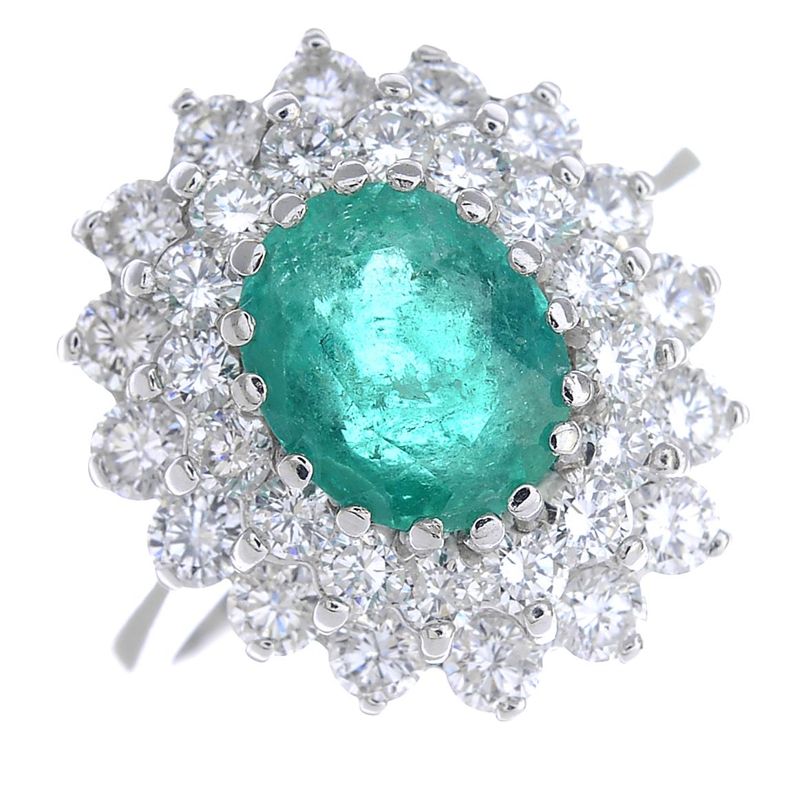 An 18ct gold emerald and diamond cluster ring.