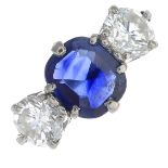 A sapphire and diamond three-stone ring.