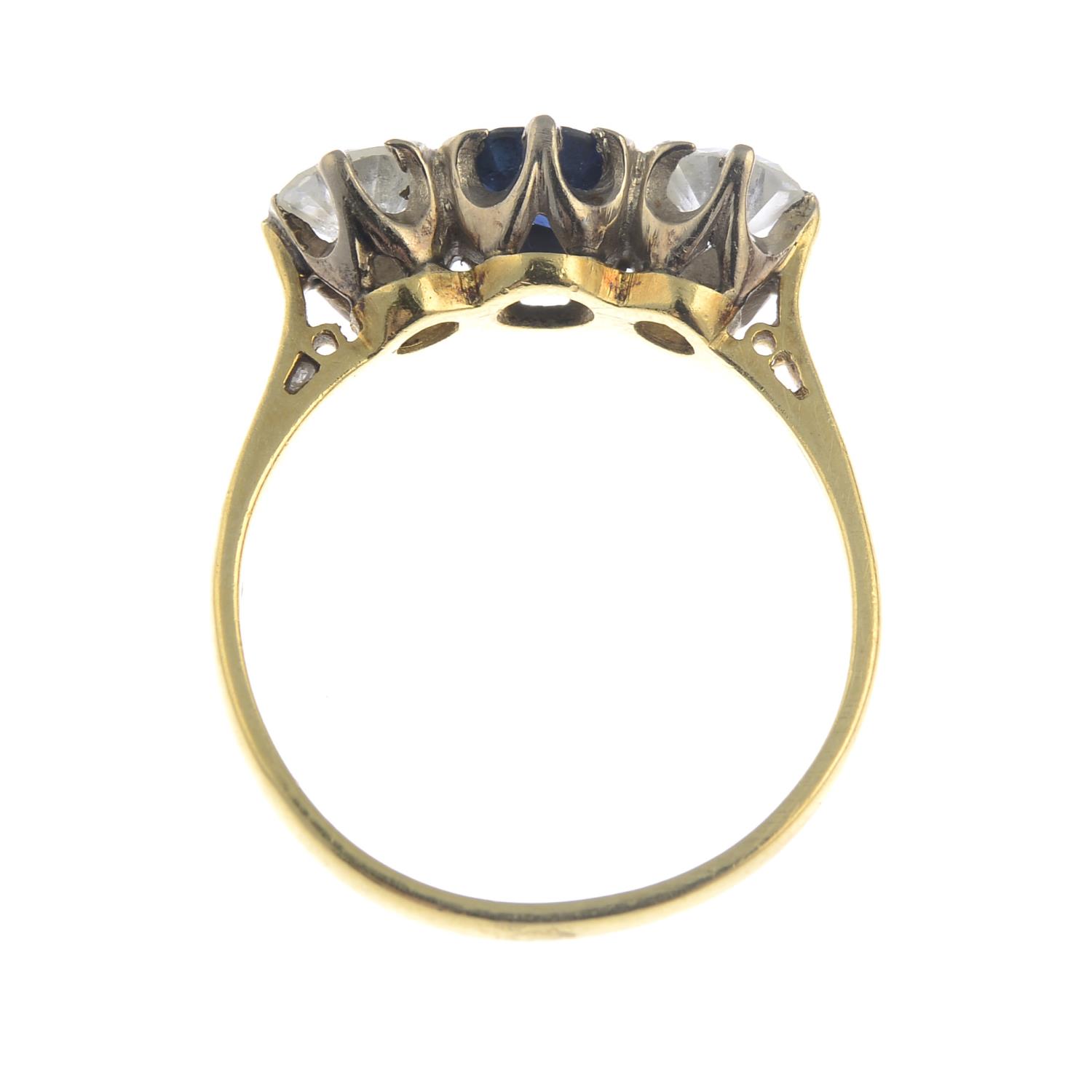 An 18ct gold diamond and sapphire three-stone ring.Estimated total diamond weight 0.80ct, - Image 2 of 3