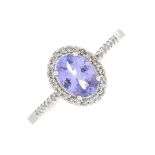 An 18ct gold tanzanite and diamond cluster ring.Tanzanite calculated weight 0.65ct,