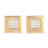 A pair of diamond earrings.