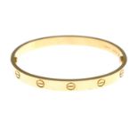 An 18ct gold 'Love' bangle, by Cartier.Signed Cartier, CNX927.