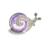 A diamond, amethyst and emerald snail brooch.Estimated total diamond weight 0.20ct.Length 1.2cms.