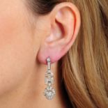 A pair of vari-cut diamond geometric drop earrings.