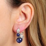 A pair of sapphire cabochon and single-cut diamond floral earrings.Sapphire calculated total weight