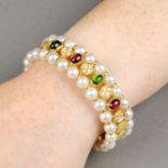 An alternating vari-hue tourmaline cabochon and pave-set diamond flexible cuff,