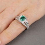 An 18ct gold emerald and diamond ring.