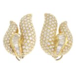 A pair of pave-set and tapered baguette-cut diamond scroll earrings.