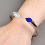 An 18ct gold pave-set diamond and lapis lazuli hinged bangle.Estimated total diamond weight 0.90ct,