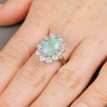 An opal and brilliant-cut diamond cluster ring.Opal weight 2.28cts.Estimated total diamond weight
