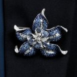 A sapphire and diamond flower brooch.May be worn as a pendant.Total diamond weight 1.80cts,