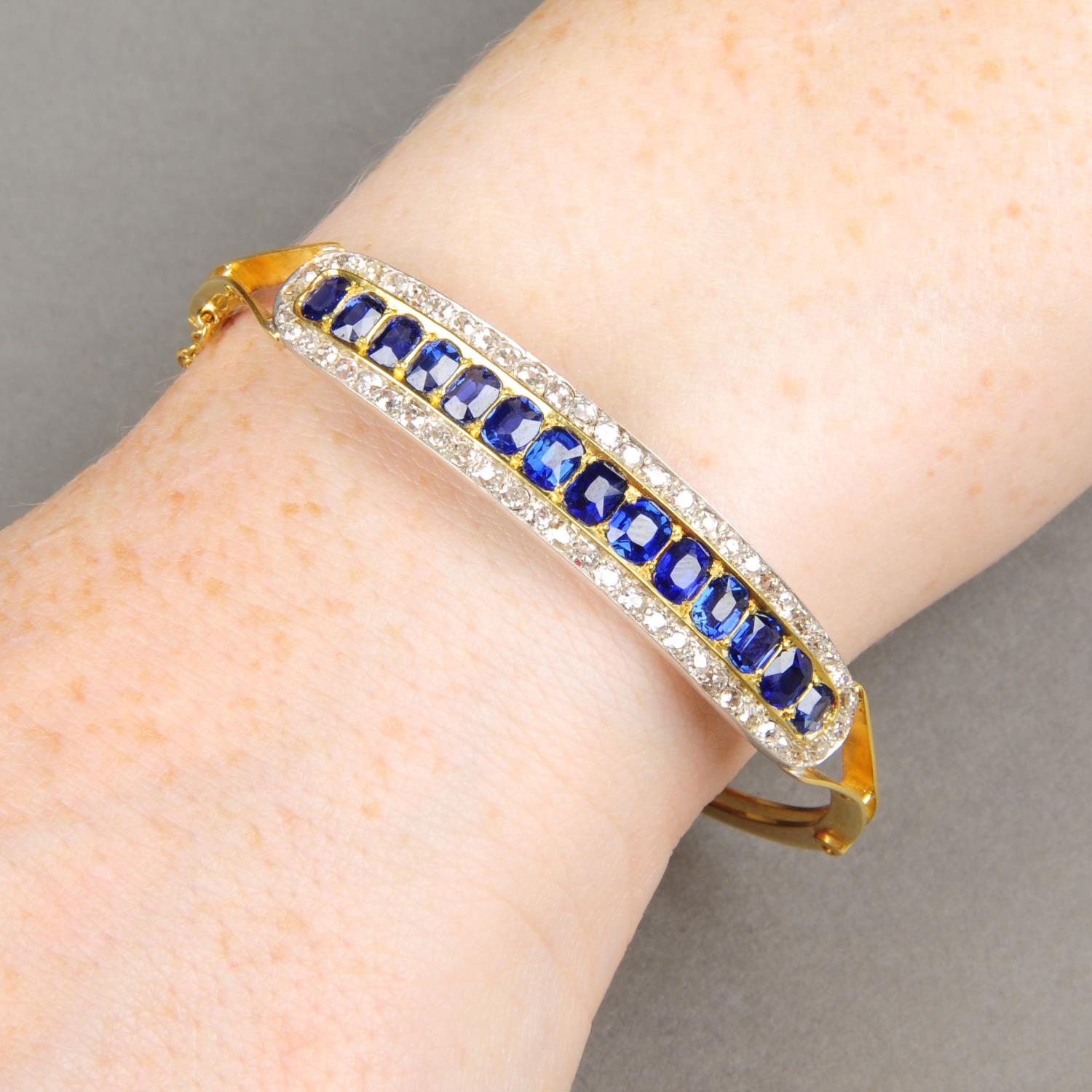 A late Victorian 15ct gold sapphire and diamond hinged bangle.Estimated total diamond weight