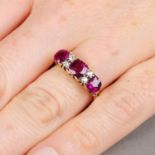 An early 20th century 18ct gold Thai ruby three-stone ring, with old-cut diamond accents.