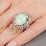 An oval opal cabochon and vari-cut diamond cluster ring.Opal calculated weight 5.43cts,