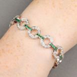 An emerald and diamond geometric link bracelet.