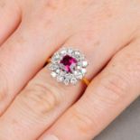 An 18ct gold ruby and brilliant-cut diamond cluster ring.