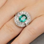 A Colombian emerald and diamond cluster ring.With report 78153-96,