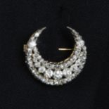 A late Victorian silver and gold, old and rose-cut diamond crescent brooch.