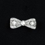 An early 20th century old-cut diamond pierced bow brooch.