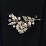 An early 20th century silver and gold old-cut diamond floral spray brooch.