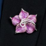 A diamond and pink sapphire flower brooch.May be worn as a pendant.Total sapphire weight 10.28cts,