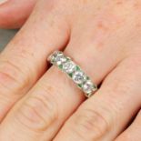 A brilliant-cut diamond full eternity ring, with calibre-cut emerald spacers.