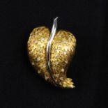 A 1960s textured leaf brooch, with single-cut diamond accents.