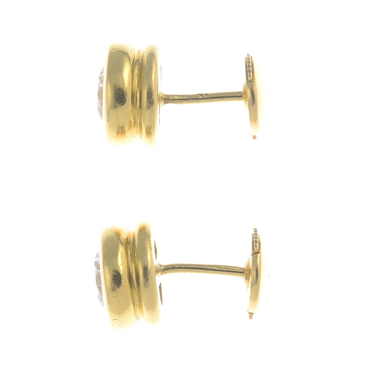 A pair of 18ct gold brilliant-cut diamond collet stud earrings. - Image 2 of 3