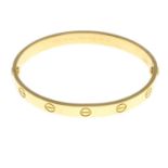 An 18ct gold 'Love' bangle, by Cartier.Swiss convention marks.Inner diameter 5.5cms.