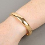 An early 20th century 15ct gold hollow, hinged bangle.Marked 15ct.