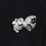 An 18ct gold diamond Pekingese dog brooch, with sapphire eyes and enamel face.