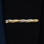 A 'Trinity' tie clip, by Cartier.Stamped 750.