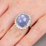 A star sapphire and brilliant-cut diamond cluster ring.